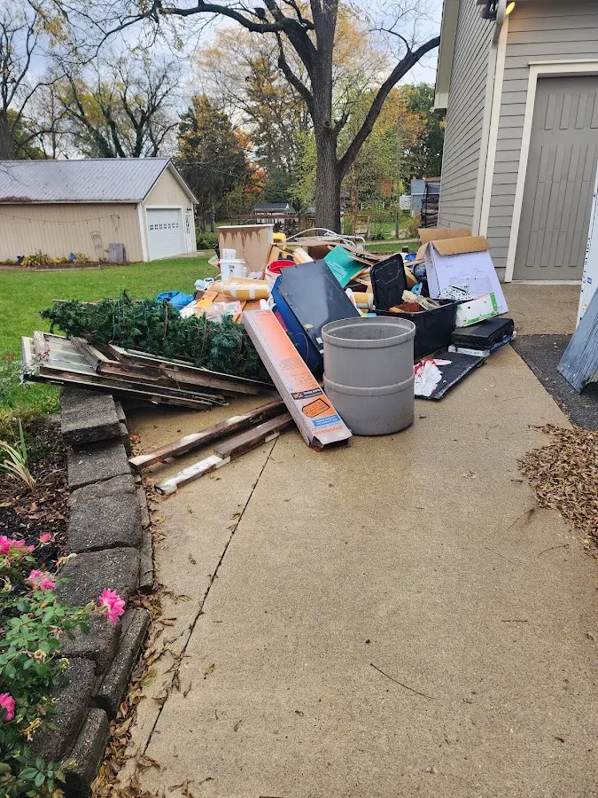 Dumpster being loaded with debris for Estate Cleanout Dumpster Rental in West Salem